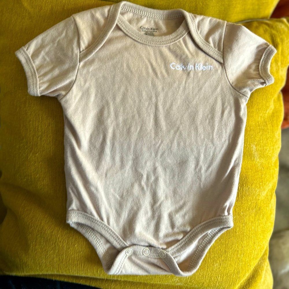 Calvin Klein Beige shirtsleeve onesie.